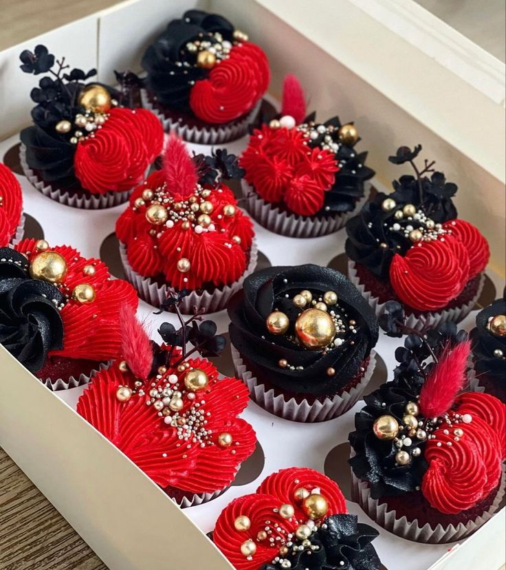 a box filled with red and black cupcakes