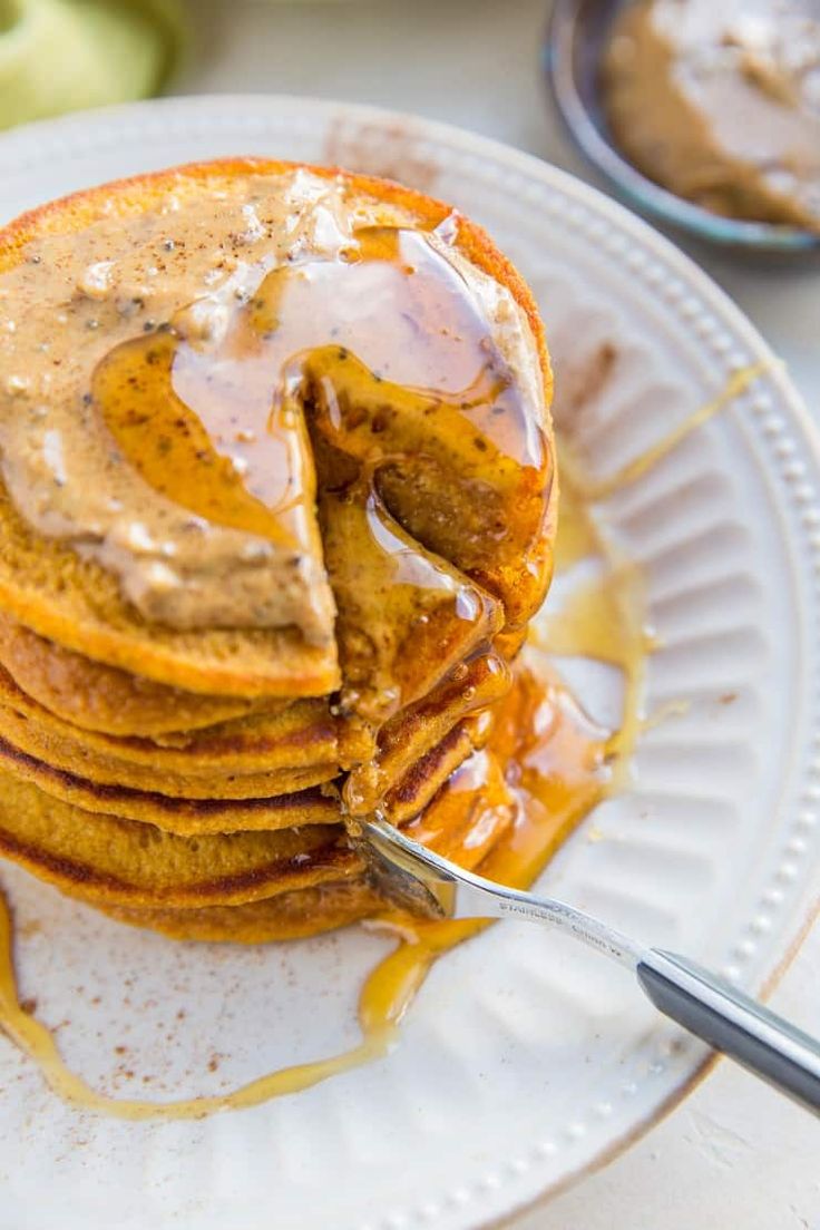 a stack of pancakes covered in caramel sauce