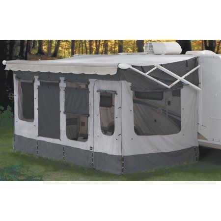 a white and gray tent with windows in the grass