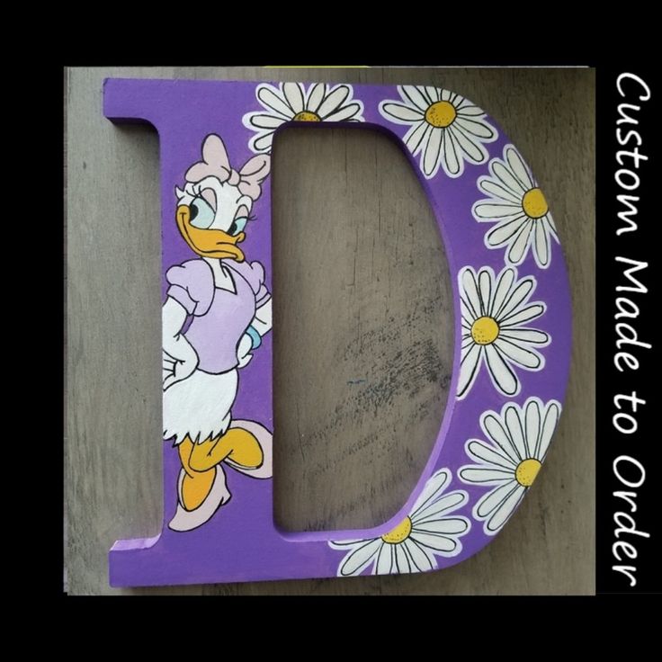 the letter d is painted with flowers and has an image of donald duck on it