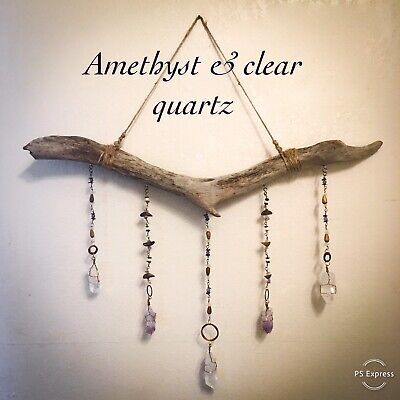 a wooden branch with beads hanging from it and the words, amethyst & clear quartz