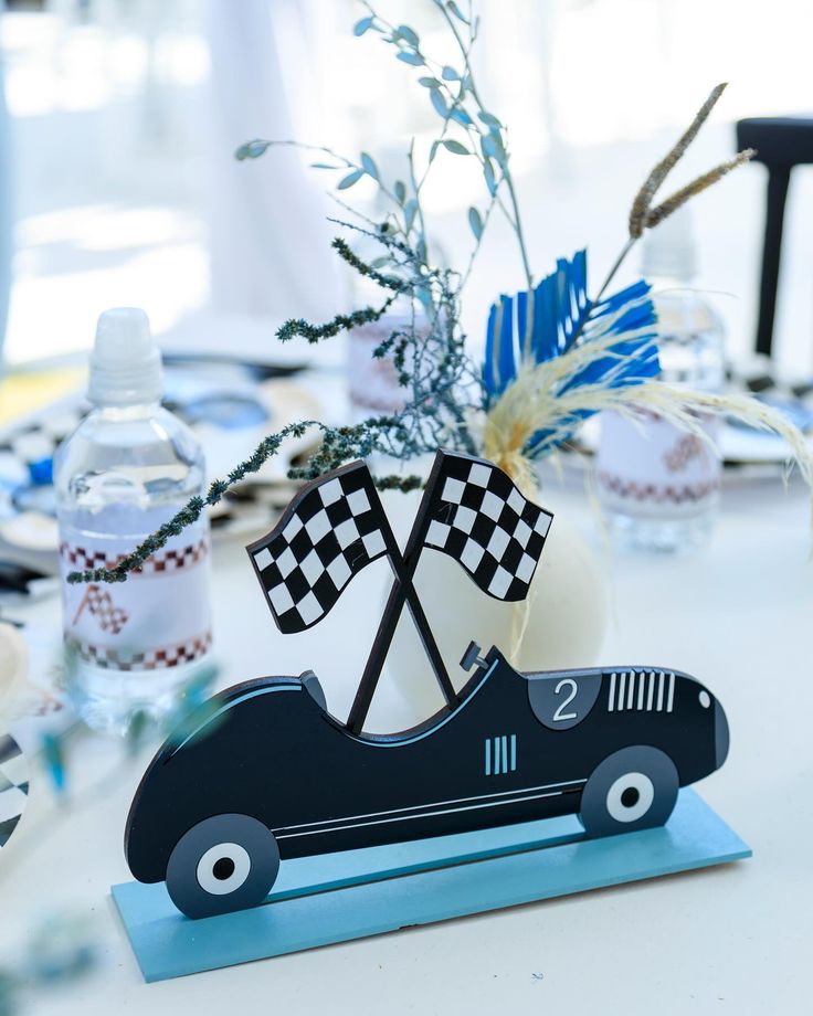 a table with a race car centerpiece on it