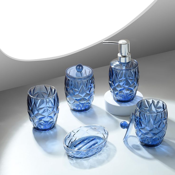 blue glass bathroom accessories set on white surface