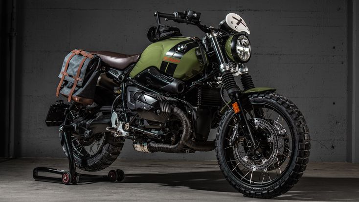 a green and black motorcycle parked in a garage