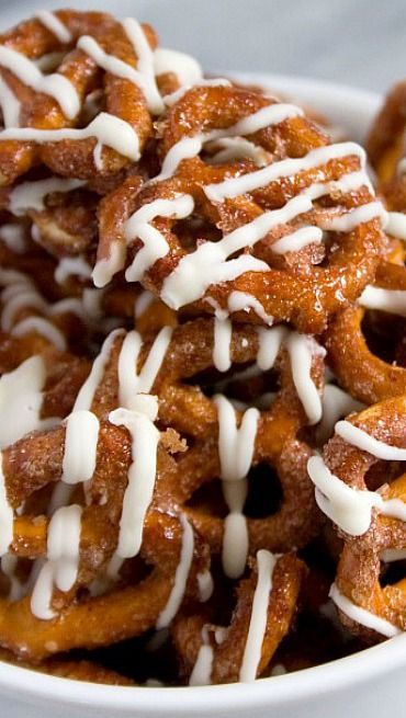 a bowl filled with pretzels covered in white icing