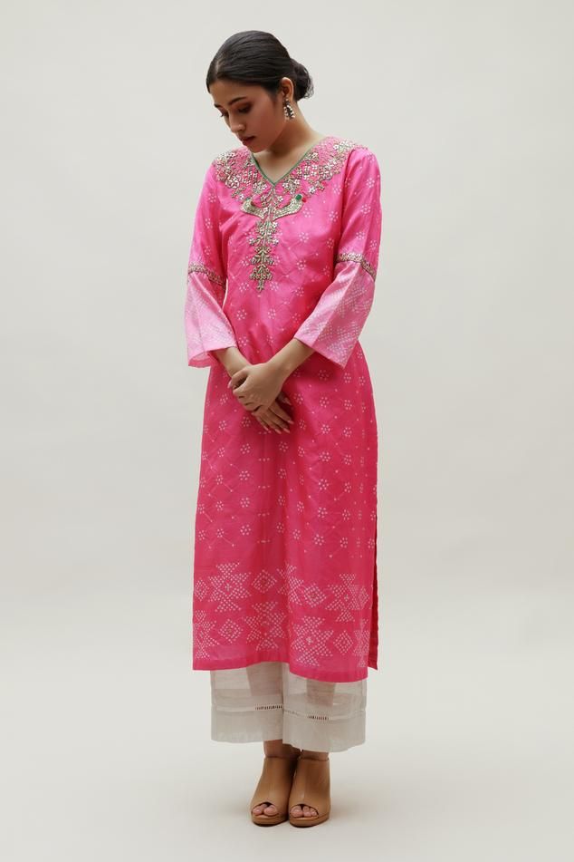 Pink silk kurta with all over bandhani pattern, floral pattern zardozi, resham embroidered yoke and sleeve panels.
Components: 1
Pattern: Embroidered
Type Of Work: Bandhani Pattern, Zardozi and Resham Work
Neckline: V Neck
Sleeve Type: Bell Sleeves
Fabric: Silk
Color: Pink
Other Details: 
Length: 48 inches
Side slits
Note: The pant worn by the model is not for sale
Occasion: Puja,Mehendi and Haldi - Aza Fashions Semi-stitched Bandhani Print Salwar Kameez, Traditional Chanderi Palazzo Set With Bandhani Print, Unstitched Chanderi Sharara With Bandhani Print, Bandhani Print Chanderi Sharara For Diwali, Festive Designer Bandhani Salwar Kameez, Designer Bandhani Print Art Silk Anarkali Set, Semi-stitched Chanderi Sharara With Bandhani Print, Designer Chanderi Sharara With Bandhani Print, Designer Chanderi Salwar Kameez With Bandhani Print