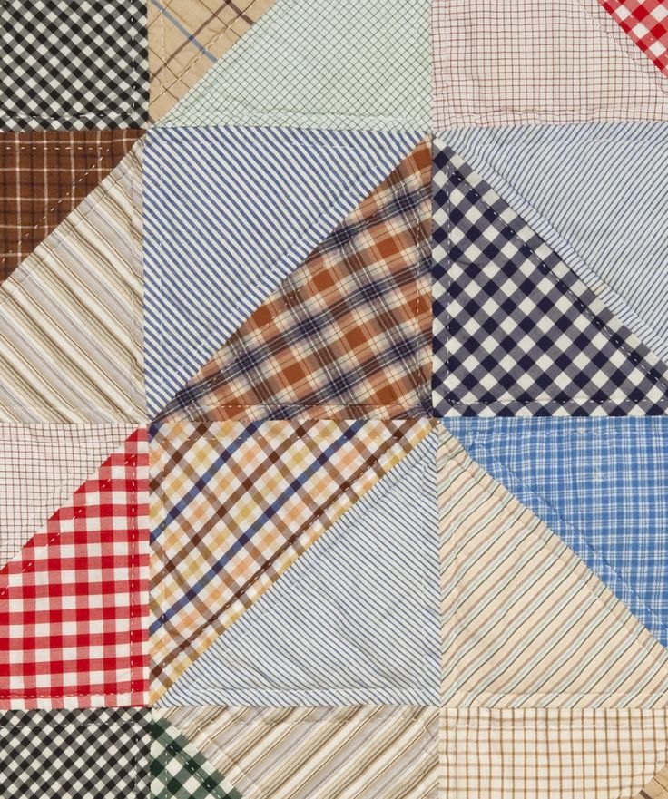 a patchwork quilt with many different colors and patterns