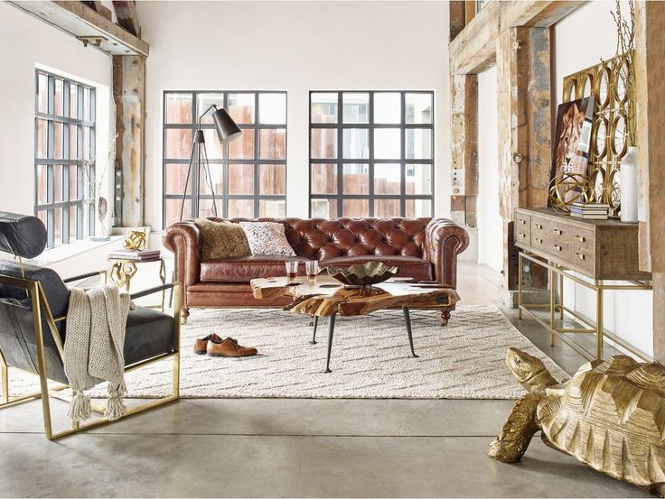 a living room filled with lots of furniture and decor on top of a carpeted floor