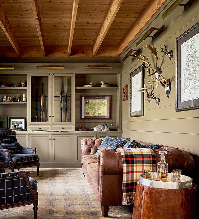 a living room filled with furniture and deer heads on the wall