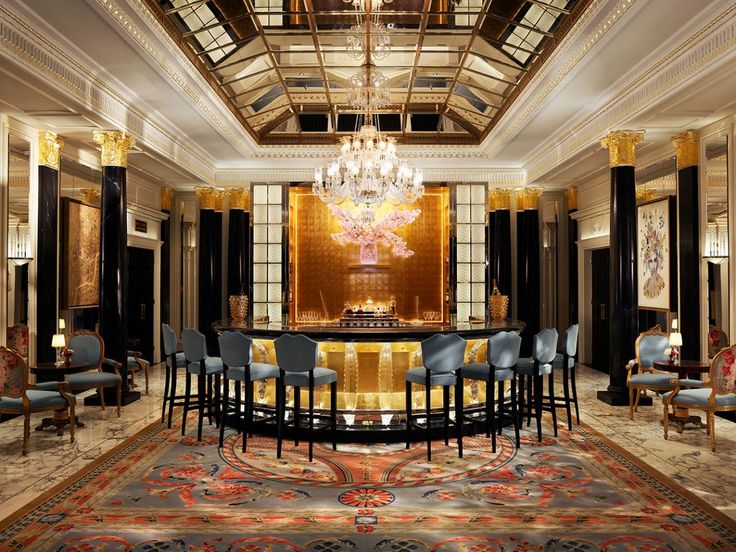 a fancy dining room with chandelier, chairs and table in the center area