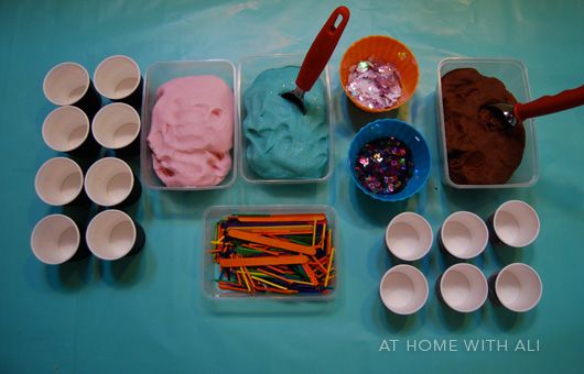 there are many different types of ice creams in plastic cups and bowls on the table