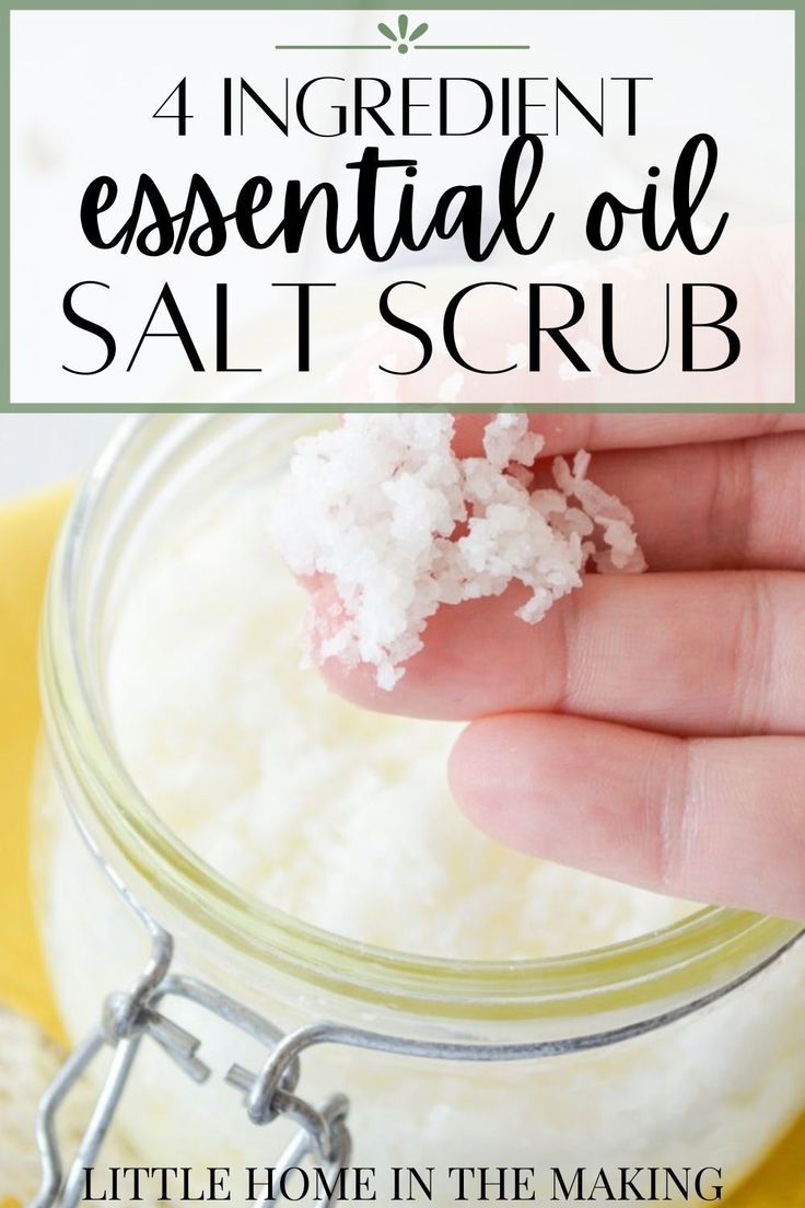 a hand holding salt in a jar with the words 4 ingredient essential oil salt scrub