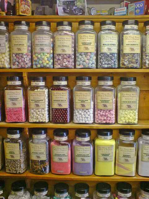 the shelves are filled with many different types of candies