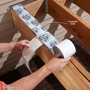 a person is wrapping a roll of toilet paper on top of a wooden bench outside