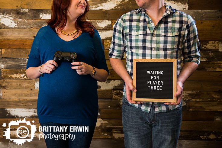 a man and woman standing next to each other holding a sign that says waiting for player three