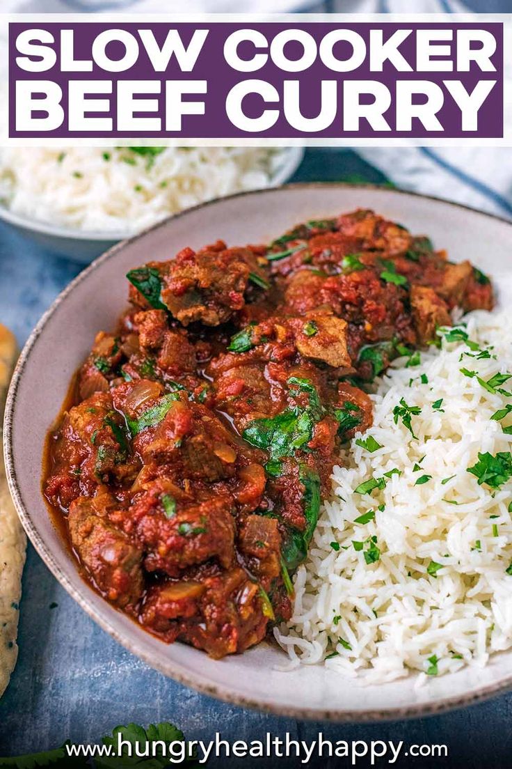 slow cooker beef curry with white rice in a bowl on a blue tablecloth