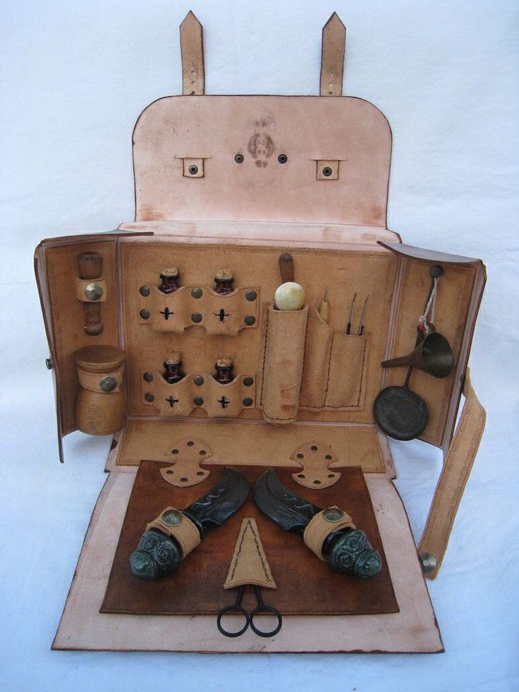 an old fashioned sewing machine with shoes and other items in the case on top of it