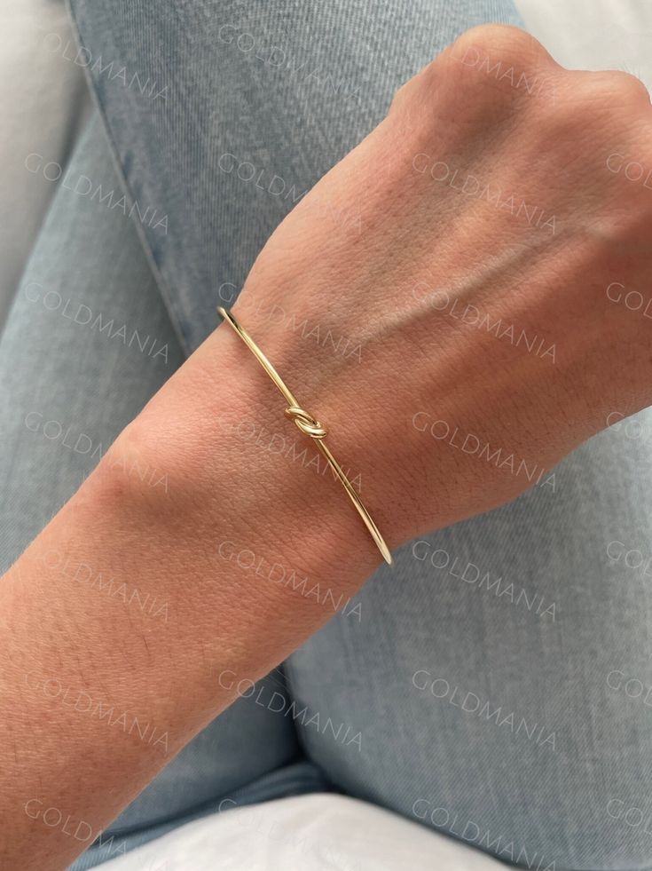 All Our Bracelets Are Made Of REAL 14K GOLD  14K yellow Gold Love Knot Cuff Bangle Bracelet, Real Gold Bangle, Stackable Bangle, Women  Shop our 14K Bracelets https://www.etsy.com/shop/GOLDMANIA?ref=seller-platform-mcnav§ion_id=26925987  Shop On Sale items https://www.etsy.com/shop/GOLDMANIA?ref=seller-platform-mcnav§ion_id=1  Metal: 14K Yellow Gold    Width: 2 MM  Length: 7 IN  Closure: Cuff Weight: 2.80 Gram   Knot dimension: 5 mm   SHIPPED FROM NEW YORK CITY FREE SHIPPING on all orders IN THE Golden Bracelet Aesthetic, Adjustable Cuff Bracelet For Anniversary, Fine Jewelry Style, Adjustable Cuff Bracelet For Anniversary In Fine Jewelry Style, Adjustable Fine Jewelry Cuff Bracelet For Anniversary, Yellow Gold Plated Cuff Bracelet For Wedding, Gold Cuff Bracelet With Bracelet Strap For Anniversary, Gold 14k Anniversary Bangle, Adjustable Yellow Gold Wedding Bangle, Modern Gold-plated Bracelets For Wedding