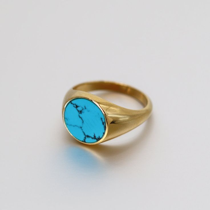 Handcrafted by Saints Gold Made to order allow 10 days to ship Solid gold signet flat ring available in 14K / 18K 14mm Natural Turquoise surrounded by solid gold 14K weight ranges from 8-10.2 grams 18K weight ranges from 10-12.2 grams Luxury Turquoise 14k Gold Ring, Handmade Yellow Gold Turquoise Ring, Handmade Turquoise Ring In Yellow Gold, Classic Gold Turquoise Ring With Round Shape, Luxury Turquoise Ring As A Gift, Luxury Turquoise Round Ring, Classic Yellow Gold Turquoise Ring, Oval Blue Turquoise Ring In 14k Gold, Classic Turquoise Signet Ring As Gift