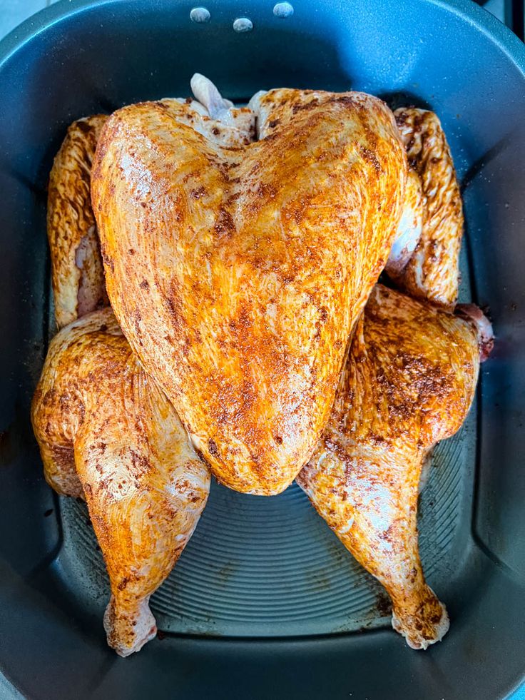 a whole chicken in a frying pan on the stove