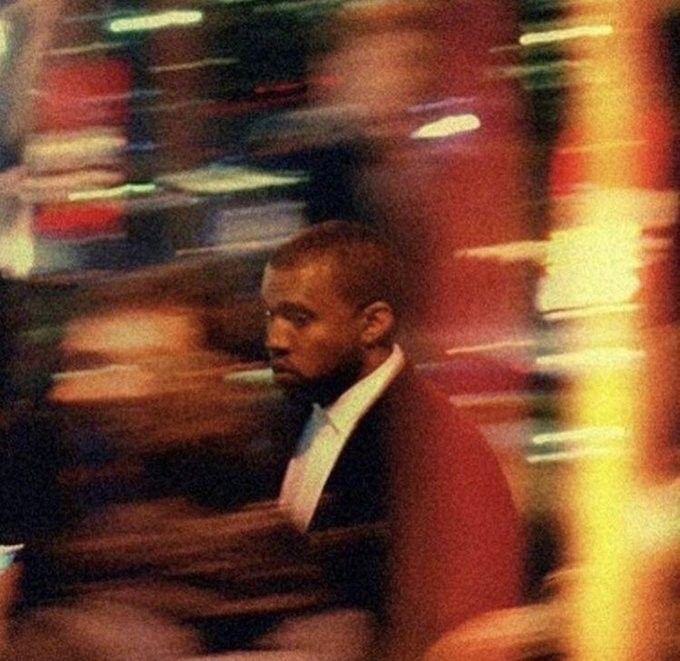 a blurry photo of a man in a tuxedo walking down the street