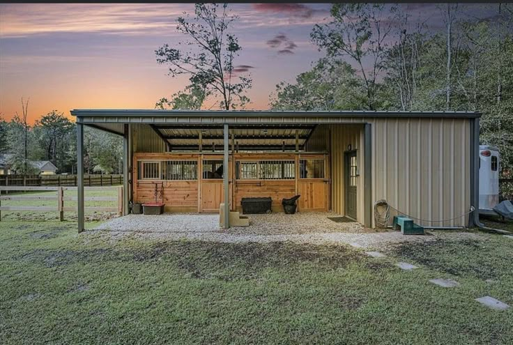 a metal shed with two doors on the front and one door open at the back