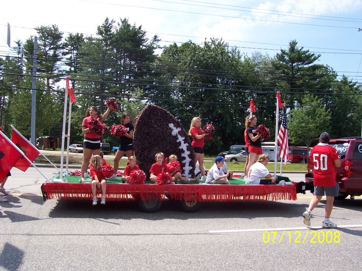 a group of people riding on the back of a red truck