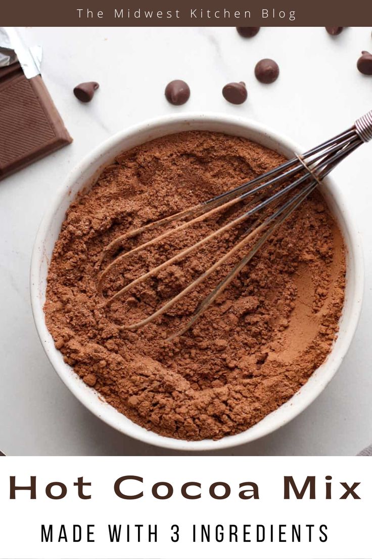 hot cocoa mix in a bowl with whisks and chocolate chips on the side