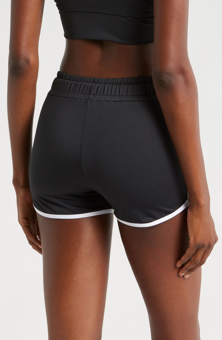 You will move with ease from land to sea in these stretch-enhanced swim shorts topped with a high waist. 3 1/2" inseam   Lined   80% recycled polyester; 20% spandex   Hand wash, line dry   Imported Athleisure Swim Skirt With Elastic Waistband, Athleisure Swim Skirt With Elastic Waistband For Workout, Short Swim Skirt With Elastic Waistband For Sports, Sporty Swim Skirt With Elastic Waistband, Sporty Short Swim Skirt With Elastic Waistband, Sporty Workout Swim Skirt, Short Length, Sporty Short Swim Skirt For Workout, Sporty Short Leg Swim Skirt For Sports, Sporty Short Swim Skirt With Moisture-wicking