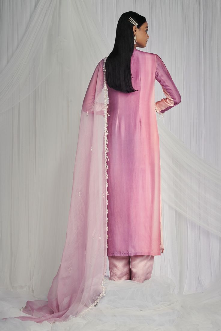 Blush pink printed kurta accented with teardrop pearl tiered and embellished detail. Paired with pure organza dupatta with hand embroidered pearl tassels on hem and pant.
Component: 3
Embellished
Neckline: Round
Sleeve Length: Full
Fabric: Kurta: 100% Pure Habutai Silk, Pant: Silk, Dupatta: Pure Organza
Color: Pink
Pearl tassels
Pure organza dupatta - Aza Fashions Pink Salwar Kameez For Celebration, Elegant Pink Chanderi Sets, Pink Cotton Silk Party Sets, Pink Cotton Silk Sets For Wedding, Pink Cotton Silk Wedding Set, Elegant Pink Sets For Transitional Season, Elegant Pink Sets For Celebrations, Transitional Pink Silk Dresses, Elegant Pink Salwar Kameez With Gota Work