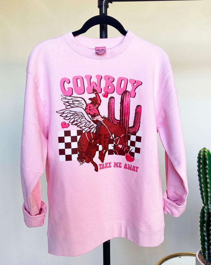 Cowboy Take Me Away Valentine's Day Graphic Sweatshirt features a super soft unisex body crewneck in pink with colorful western graphic art. Decorated at our headquarters in Tolar, Texas. Sizes Available: S-XXL Winter Crew Neck Pink Top, Pink Graphic Print T-shirt For Loungewear, Pink Crew Neck Top For Winter, Pink Long Sleeve T-shirt With Graphic Print, Winter Pink Crew Neck Top, Pink Long Sleeve Sweatshirt With Graphic Print, Pink Graphic Print Top For Fall, Casual Pink Sweatshirt With Graphic Print, Pink Crew Top For Fall