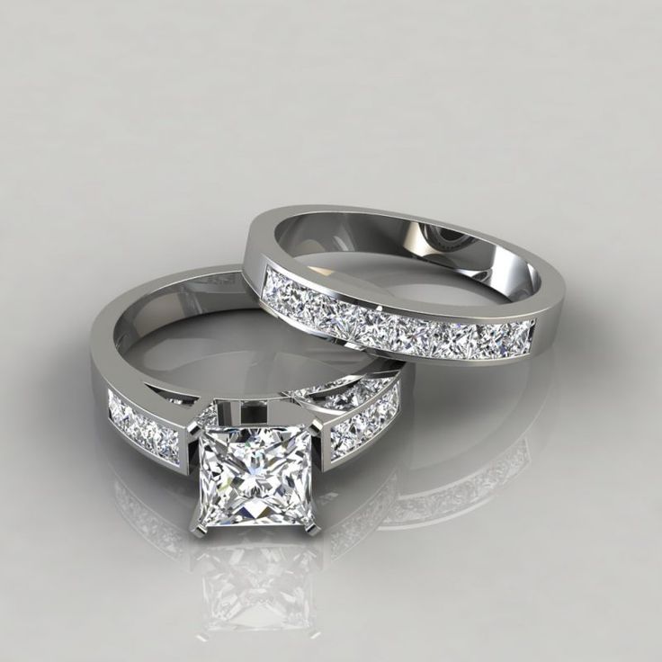 two white gold wedding rings with princess cut diamonds on each side and channel set in the middle