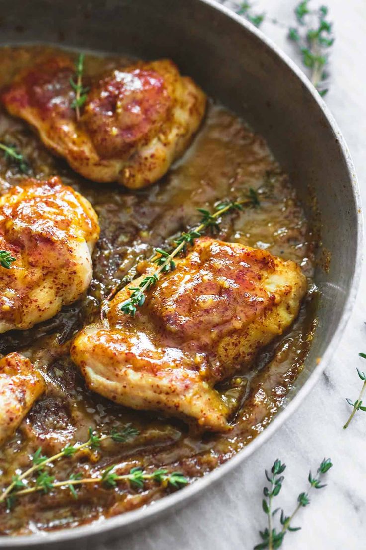 some chicken is cooking in a pan on the table