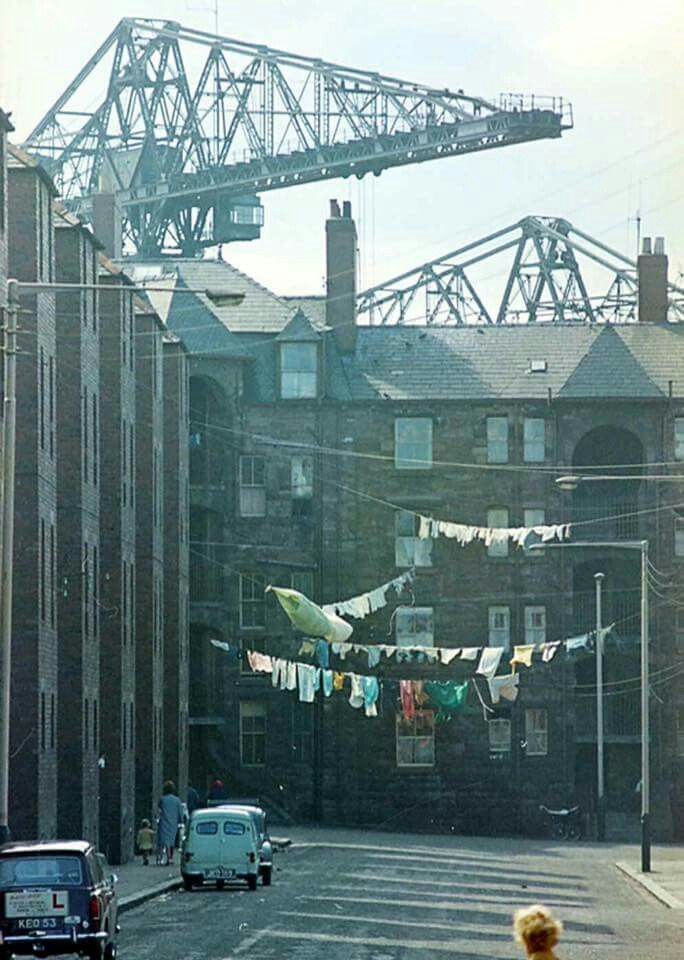 an airplane is flying in the sky over a city street