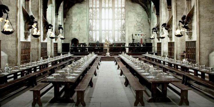 a large dining hall with long tables and benches in it's centerpieces