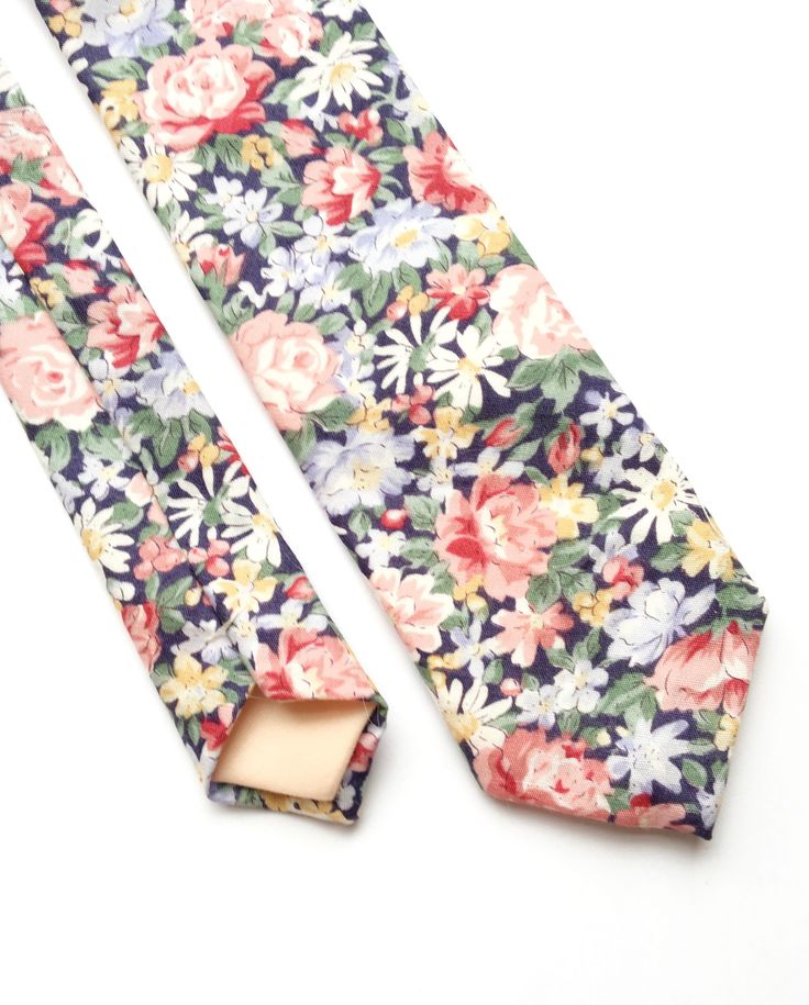 DESCRIPTION: This pretty men's skinny tie has been handmade using cotton with a mixed floral print. Available in skinny and regular widths. FABRIC: Cotton. LINING FABRIC: Cotton. -------------------------------------------------------------------------------------------- DETAILS: * Made the traditional way with fabric cut on the bias * Each tie has canvas lining throughout * Fabric lining just at the tip on each end of the tie * Available in two widths Widths. Skinny width at widest part is appr Spring Suit And Tie Accessories For Black Tie Events, Spring Black Tie Event Ties, Cotton Ties For Black Tie Occasions In Summer, Cotton Ties For Black Tie Events In Summer, Elegant Summer Floral Print Ties, Summer Floral Print Ties, Elegant Floral Print Summer Ties, Summer Formal Suit And Tie Accessories With Floral Print, Summer Formal Ties With Floral Print