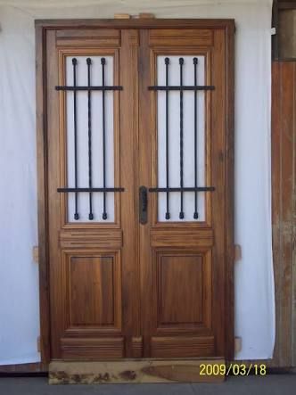 two wooden doors with iron bars on them