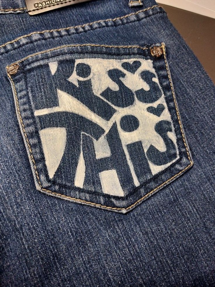 the back pocket of a pair of jeans with graffiti on it