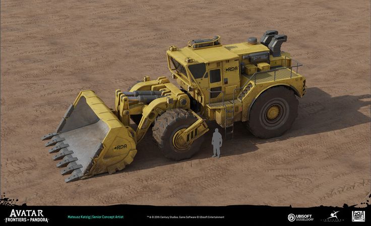 a man standing next to a large yellow bulldozer on top of a dirt field