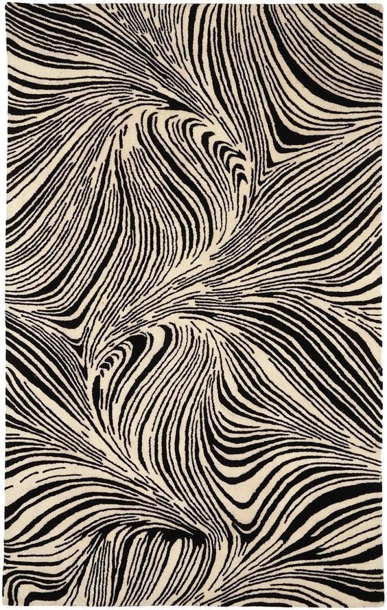 a black and white rug with wavy lines on the bottom, in an abstract manner