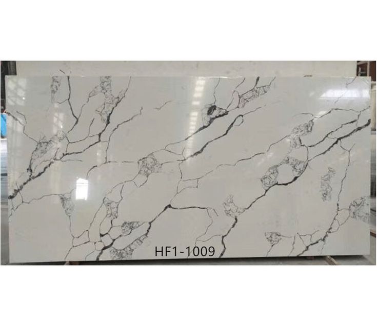 white marble with black veining on the top and bottom, is displayed in a store