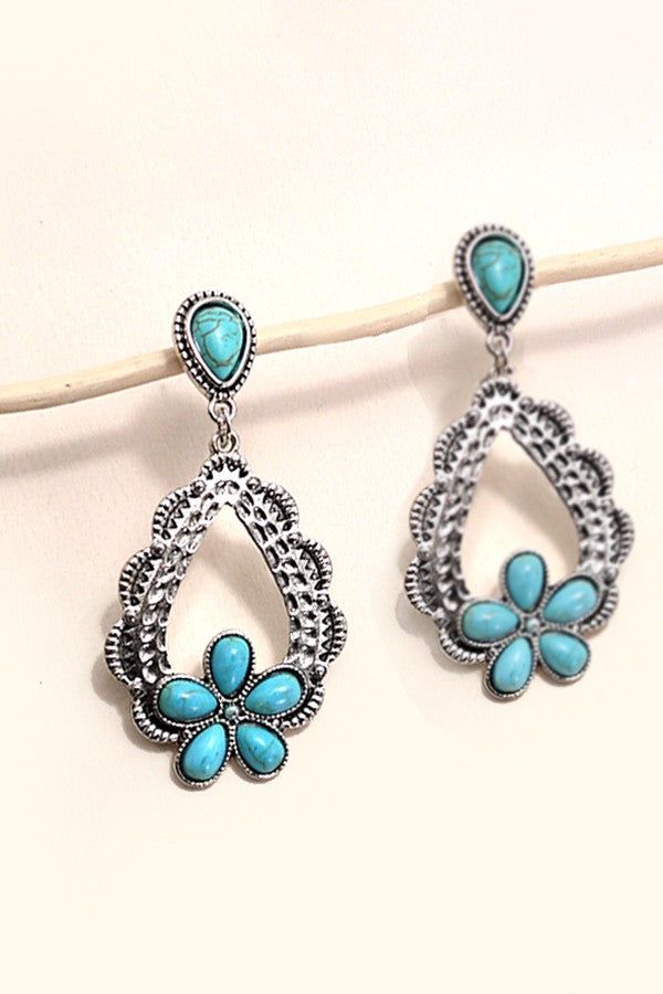 Western Turquoise Flower Drop Earrings, a stunning blend of Western charm and timeless elegance. These earrings feature intricately crafted turquoise flowers suspended from delicate drops, capturing the essence of the Southwest with a touch of sophistication. ??Each earring showcases the beauty of turquoise stones in a floral motif, evoking the rugged beauty of the Western landscape. Whether you're exploring the open range or stepping out for a night on the town, these earrings are sure to make Cheap Turquoise Dangle Flower Earrings, Bohemian Turquoise Flower Shaped Jewelry, Bohemian Turquoise Flower-shaped Jewelry, Turquoise Dangle Earrings With Flower Charm, Bohemian Blue Teardrop Flower Earrings, Blue Bohemian Teardrop Flower Earrings, Elegant Turquoise Earrings With Flower Charm, Blue Teardrop Bohemian Flower Earrings, Turquoise Flower Charm Dangle Jewelry