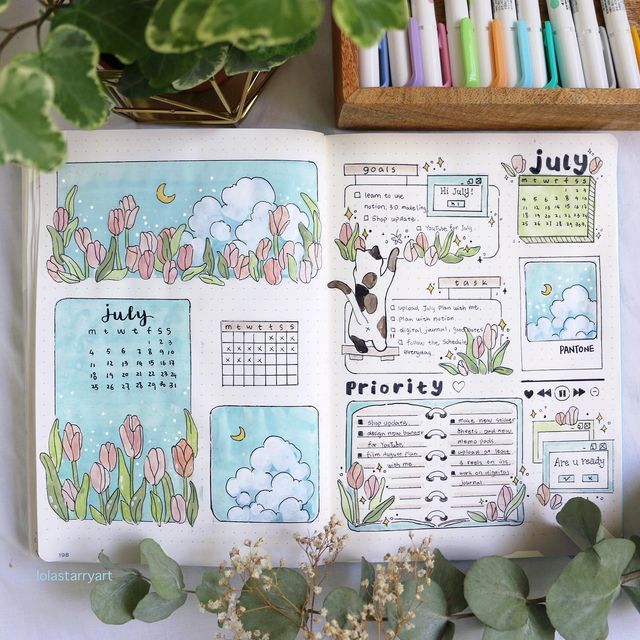 an open planner with flowers and plants on it