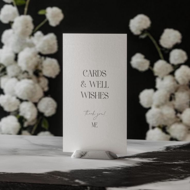 a card that says cards and well wishes on it next to some white carnations