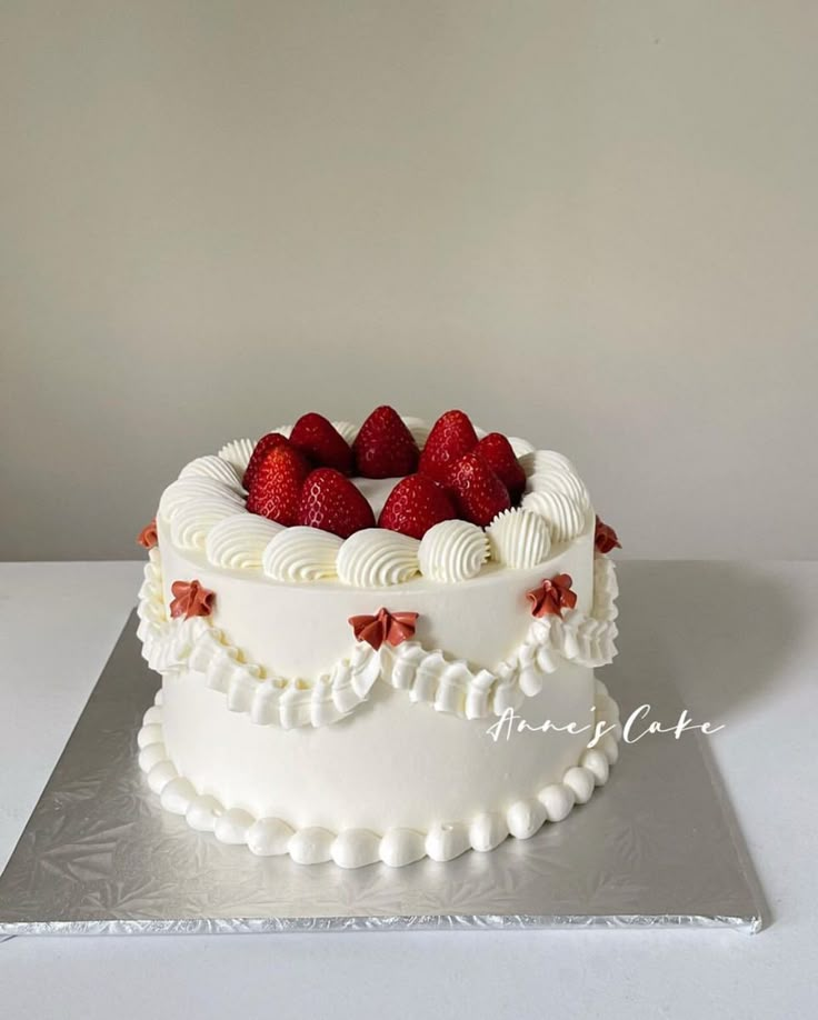 a cake with white frosting and strawberries on top