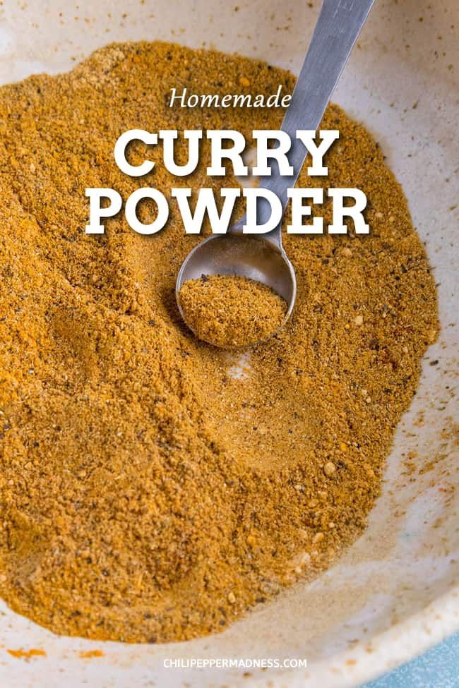 homemade curry powder in a white bowl with a spoon on the side and text overlay that reads homemade curry powder