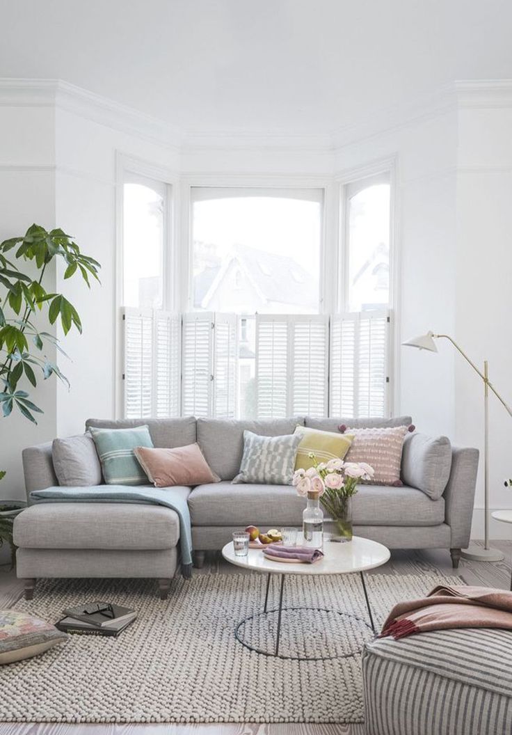 a living room filled with furniture and plants