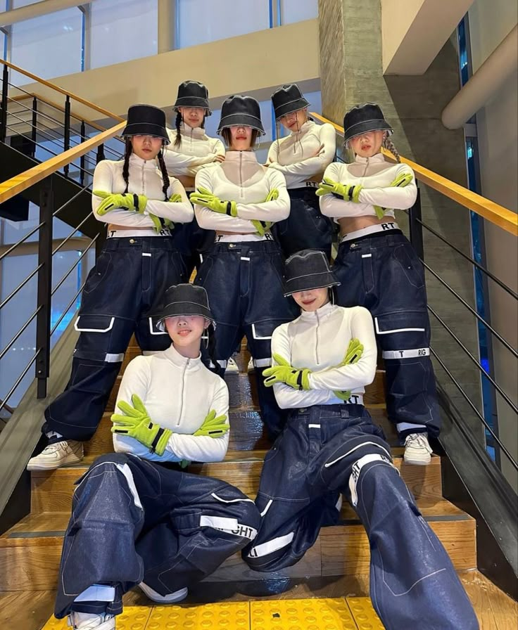 a group of young women sitting on top of stairs