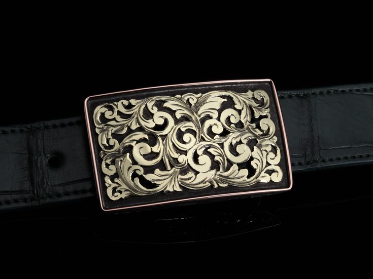 The Tyson Churchill 18k is an exclusive Comstock Heritage web piece created with a good friend in mind with it's sleek and yet bold design. Starting with a Sterling silver "Tyson" buckle base that has been antiqued for a dark background, we then add hand carved 18k green gold filigree in the center and 14k rose gold wire surrounding. This buckle is a first of it's kind with it's all green gold center. Hidden above and below this buckle are Sterling silver sides that have been hand engraved for a Formal Gold Engraved Belt Buckles, Elegant Engraved Gold Belt Buckles, Elegant Gold Engraved Belt Buckles, Timeless Gold Belt Buckles For Formal Wear, Classic Polished Belt Buckles For Formal Occasions, Antique Engraved Belt Buckles For Formal Wear, Luxury Engraved Silver Belt Buckles, Luxury Gold Belt Buckles, Formal Engraved Belt Buckles