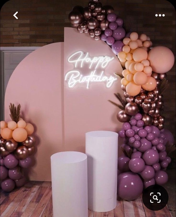 balloons and candles are arranged in front of a happy birthday sign